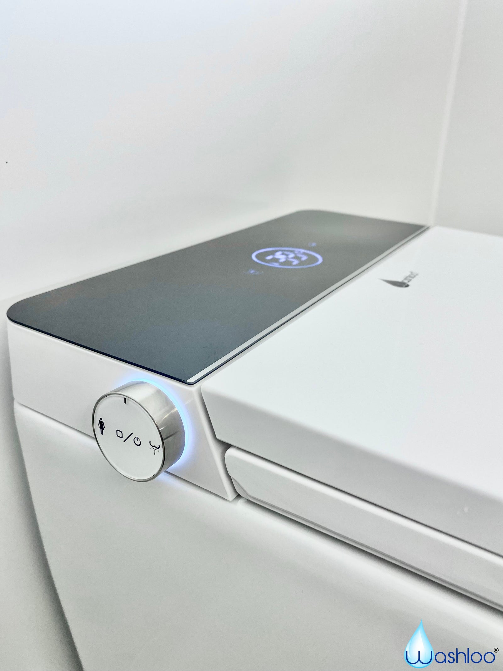 A minimalist studio product photograph of a standalone Washloo all-in-one Prestige toilet showing its seamless white ceramic body and back-to-wall mounting shroud against a clean white background.
