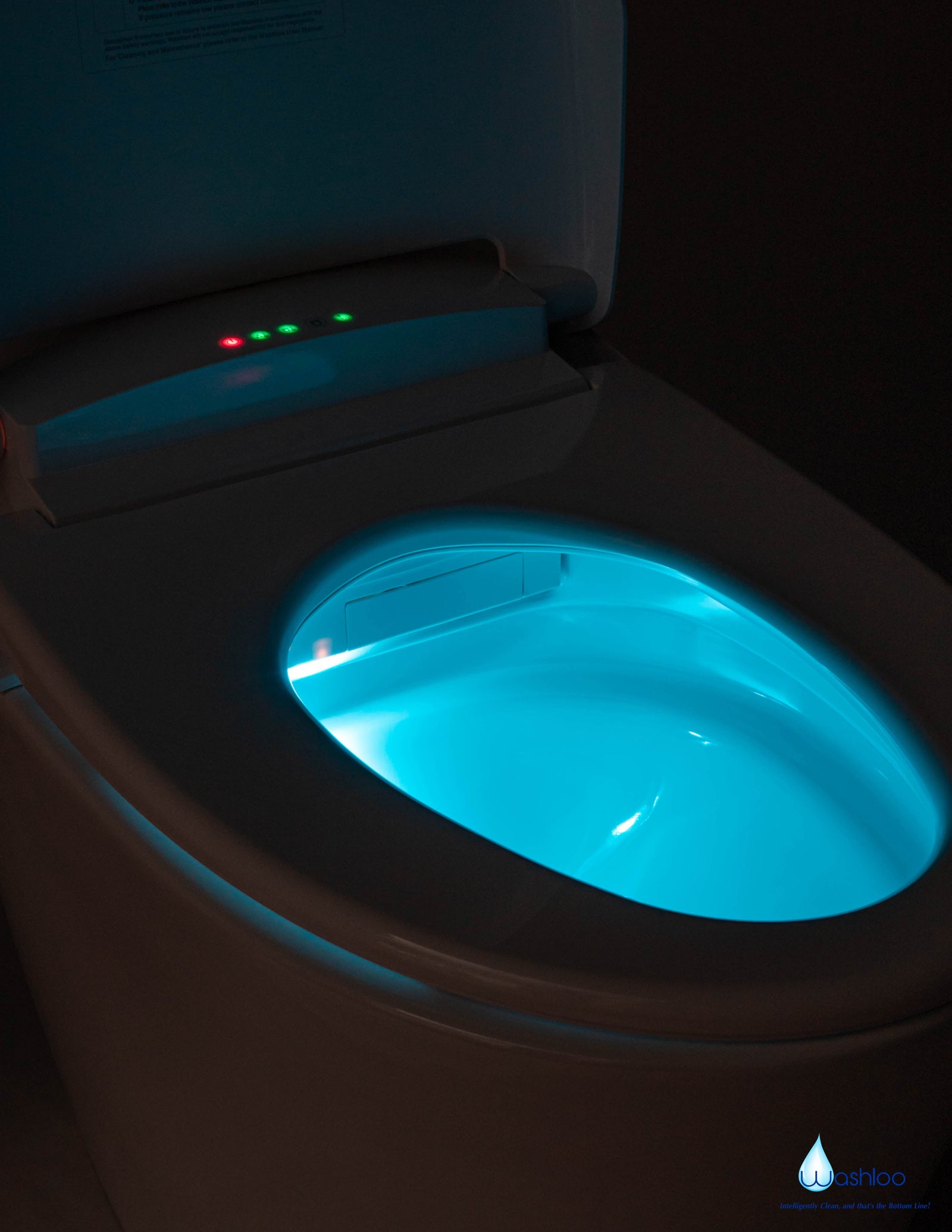 A dark bathroom illuminated safely by the soft blue-free LED night light of a modern Washloo smart toilet seat.