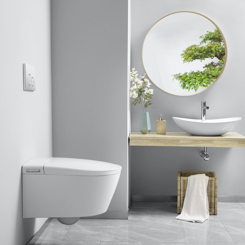 A bright, high-end bungalow en-suite bathroom showcasing an elegant, space-saving smart toilet combination with modern stone tiling.